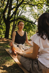 Mentor and student before Mindful meditation and yoga in an open area. Deep relaxation and inner...