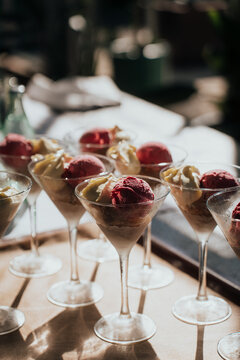 Elegant dessert presentation with ice cream and fruit in martini glasses