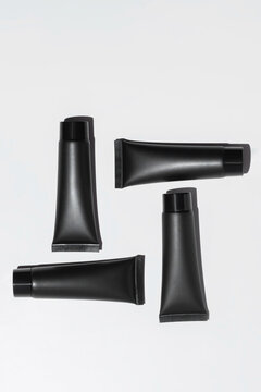 Black Cosmetic Tubes on White Background