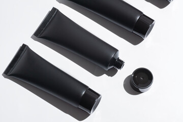 Black Cosmetic Tubes on a Clean White Background