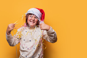 Preteen girl celebrating with Christmas streamers