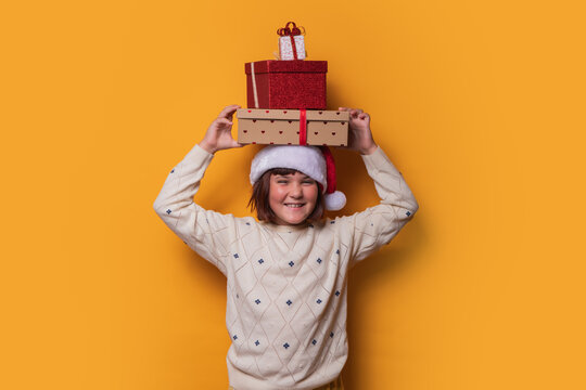 Preteen girl with Christmas gifts, joyful expression