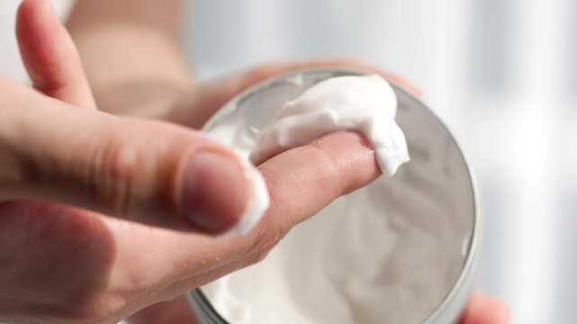 Hand cream in large plan.
A man smears his hands with cream.
Wet hands.
Dry hands.
Problems with the skin on the hands.
Palms in cream, close-up