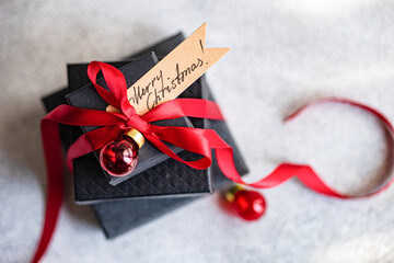 Top view of a Christmas gift with a festive greeting card
