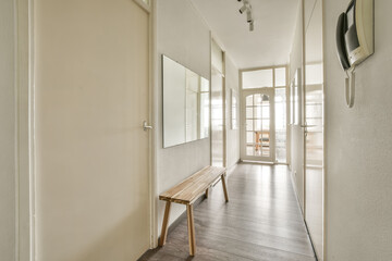 Bright hallway interior with wooden bench and phone