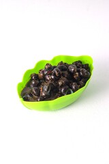 A bowl filled with cooked river snails (tutut) in a spicy sauce. Tutut is a popular dish in some regions of Indonesia, made from freshwater snails.