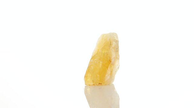 mineral stone citrine rotates in a circle on a white background