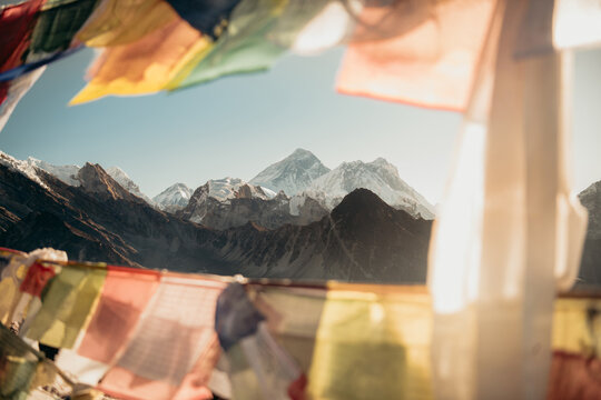 Snow-capped Mount Everest framed by colorful prayer flags
