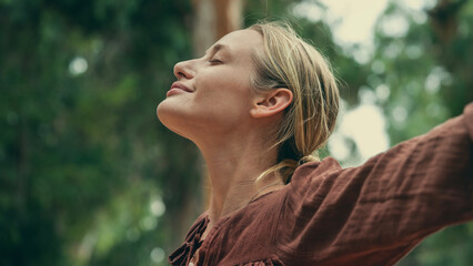 Woman breathing fresh air outdoors 