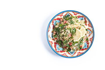 Tabbouleh salad with couscous and vegetables isolated on white background. Top view. Copy space