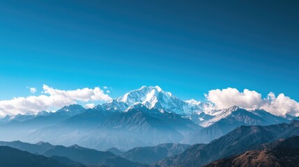 Fototapeta premium A breathtaking mountain range with snow-capped peaks under a clear blue sky, offering wide space for text. Perfect for outdoor adventure or travel promotions.
