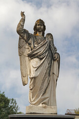 an angel statue made from a light stone