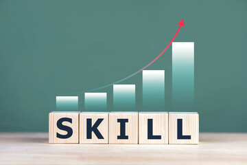 Concepts of skill development and enhancement, academic and vocational skills training. SKILL on wooden blocks with increasing arrows.