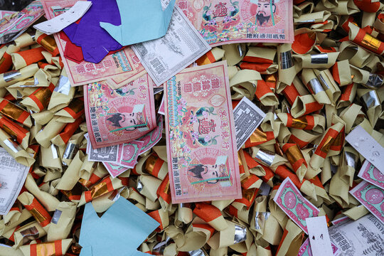 Chinese hungry ghost festival prayer offering joss paper money candle burning fire flame smoke