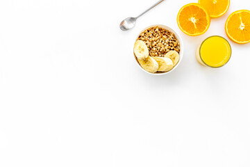 Healthy granola and orange juice for colorful breakfast on white background top view mock-up