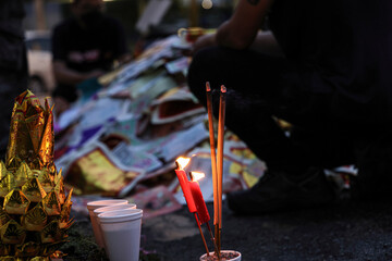 Chinese hungry ghost festival prayer offering joss paper money candle burning fire flame smoke