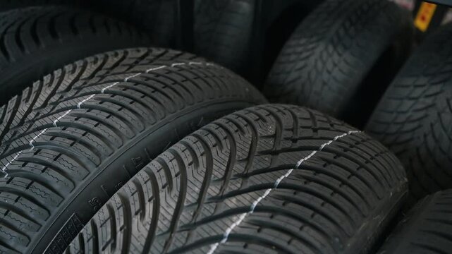 A new tire is placed on the tire storage rack in the tire shop