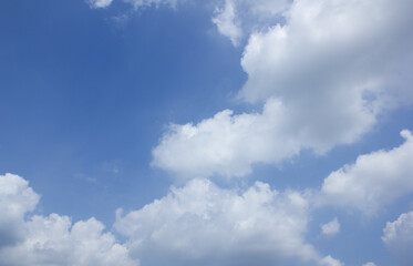 A blue sky with puffy clouds.