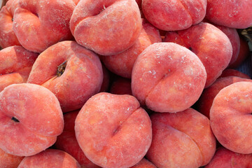close up of flat peaches fruit background.