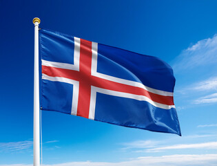 The flag of Iceland fluttering in the wind with blue sky background