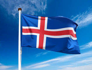 The flag of Iceland fluttering in the wind with blue sky background