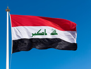 The flag of Iraq waving in the wind with blue sky background © sebi_2569