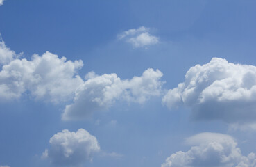 A blue sky with puffy clouds.