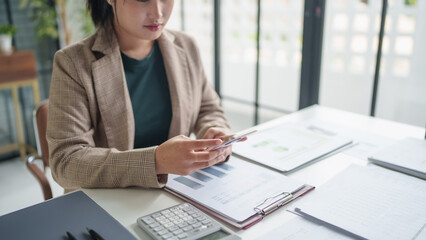 Asian woman using smartphone mobile addict spending time checking news social media cell telephone technology e-commerce concept.