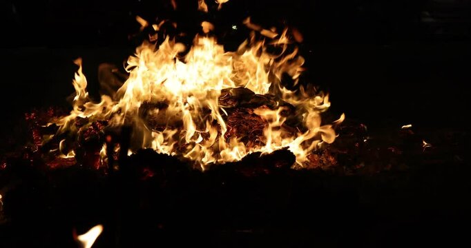 Chinese hungry ghost festival prayer offering joss paper money candle burning fire flame smoke