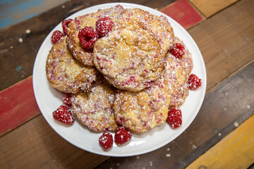 A display of freshly home baked delicious Raspberry and White Chocolate Cookies on a kitchen table