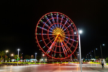 A red Ferris wheel, giant wheel, panoramic wheel in Batumi, Georgia.