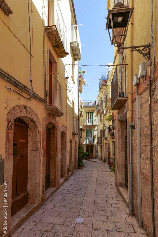 Poster a street between old houses of isernia, a city in molise, italy.