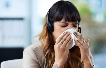Sick, woman and blowing nose with headset in office for virus, illness and allergy symptoms. Sneezing, disease and tissue with customer support suffering with infection for flu, fever and cold