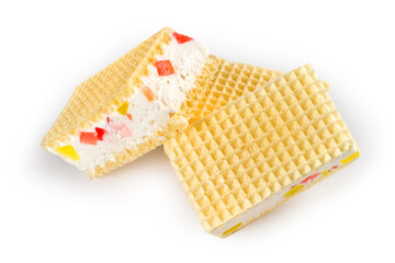 Waffle cakes with filling and marmalade. A pile of waffle cakes on a white background.