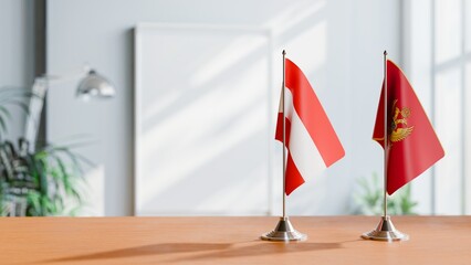 FLAGS OF AUSTRIA AND MONTENEGRO ON TABLE