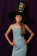 One Biracial Teenage Girl Posing for Picture at New Year's Eve Party, in Front of Purple Backdrop, vertical