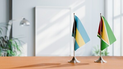 FLAGS OF BAHAMAS AND GUYANA ON TABLE