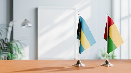 FLAGS OF BAHAMAS AND GUINEA-BISSAU ON TABLE