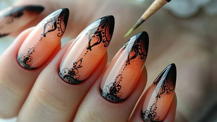 nail art design featuring black lace patterns on orange