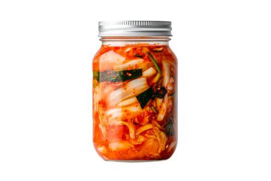 Kimchi cabbage prepared with vegetables, crisp bok choy lettuce, red chili and green onion in a glass jar