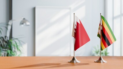 FLAGS OF BAHRAIN AND ZIMBABWE ON TABLE