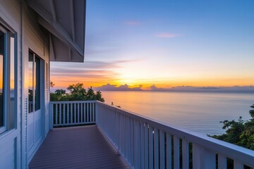 A cozy balcony with a panoramic seaside view, showcasing the peaceful outlook of the horizon at sunset