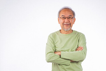 Portrait Asian grey haired smiling senior man with arms crossed studio shot isolated on white...