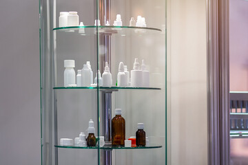 Various bottles for eye drops and medications on a stand