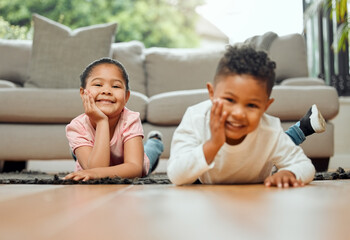 Portrait, kids and happy siblings on floor in home for relax, love and children bonding together in living room. Face, brother and sister smile on carpet with family, boy and cute young girl in house