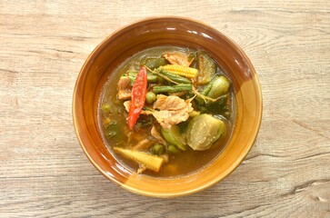 spicy boiled pork with mixed vegetable in jungle curry soup Thai food in bowl