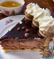 Plate with slice of tasty homemade chocolate cake on table