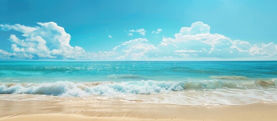 Beautiful tropical beach with turquoise sea water against a blue sky background ideal for a summer background and vacation concept with copy space image