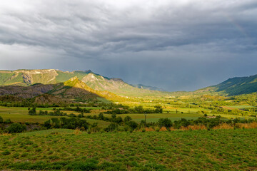 View to a mountain ridge in the French Maritime Alps with haze and heavy cloud cover.
