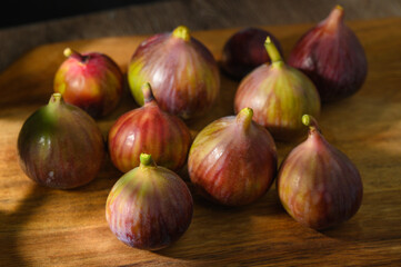 Fototapeta premium Fresh figs. Food Photo. Creative diagram of the whole on a wooden background. Top view.